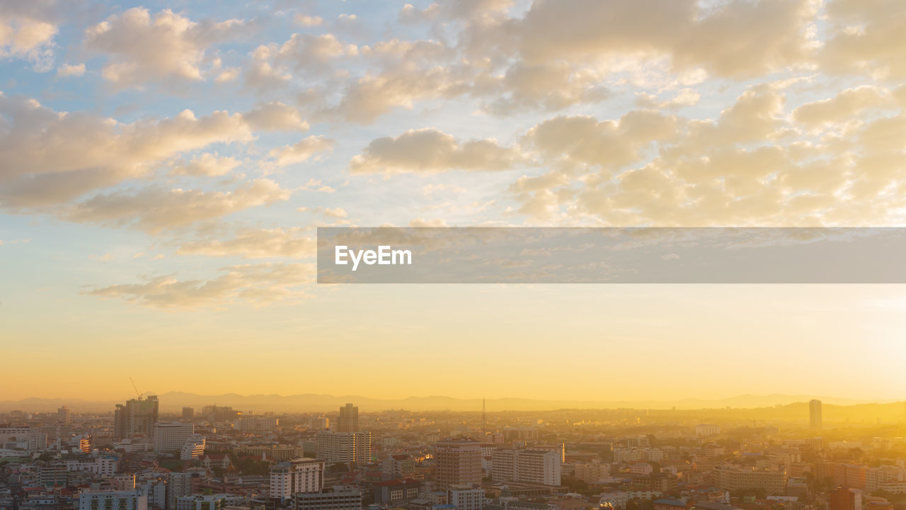 HIGH ANGLE VIEW OF BUILDINGS IN CITY DURING SUNSET