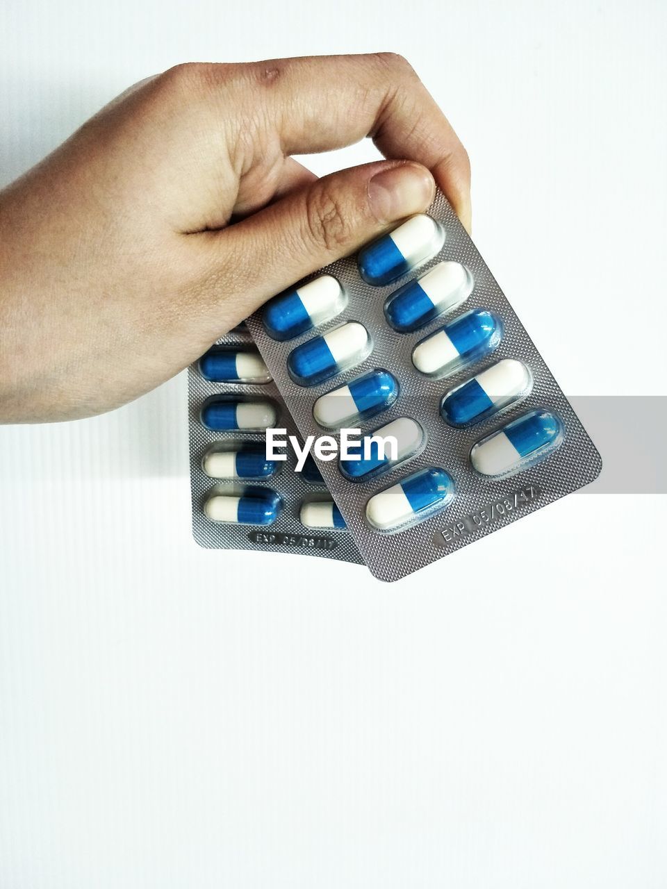 CLOSE-UP OF HUMAN HAND ON WHITE BACKGROUND