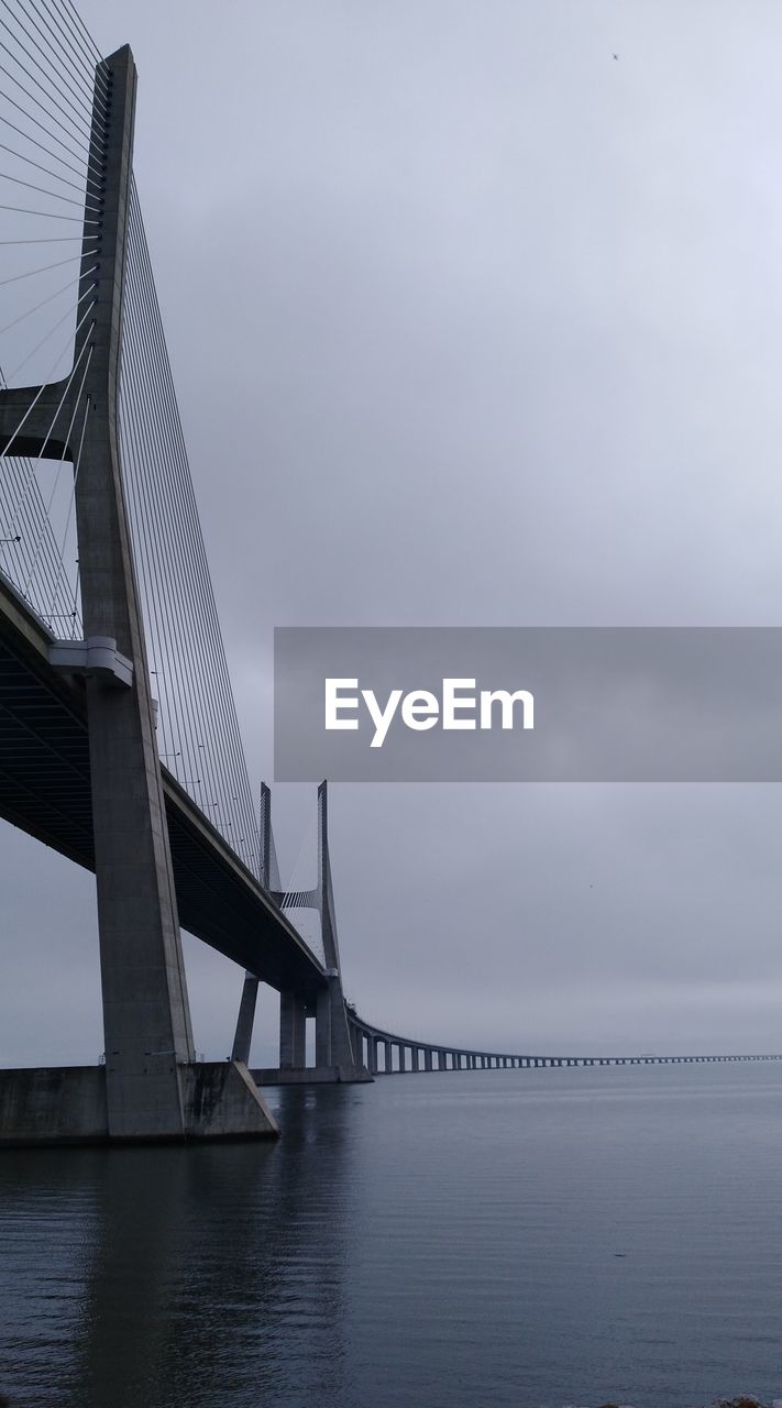 Low angle view of bridge over calm sea