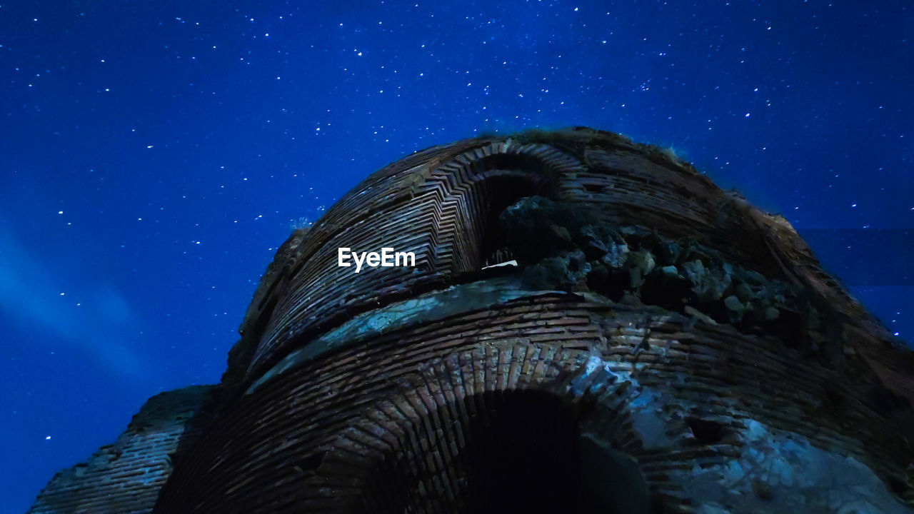 Low angle view of an old church ruin from the 5th century and the night sky 