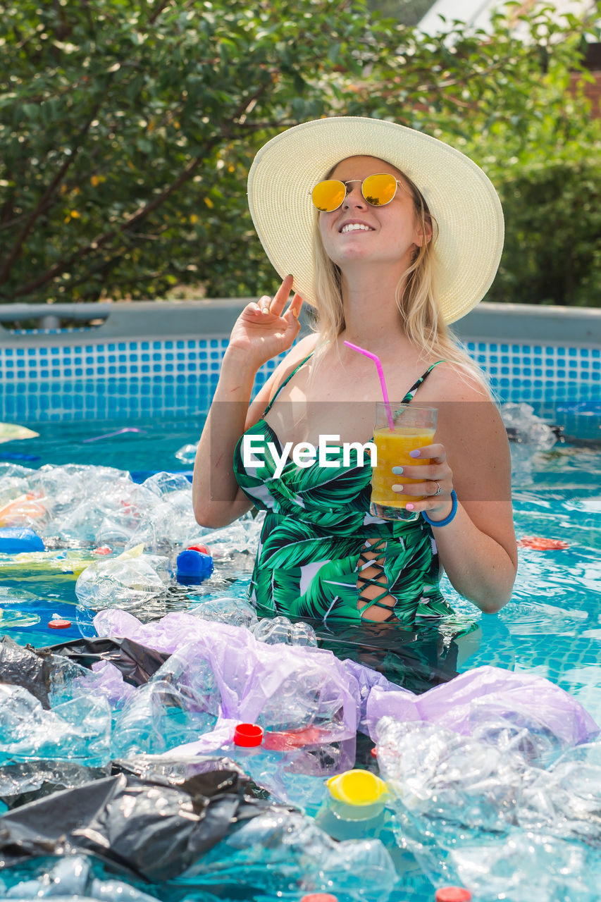 WOMAN WEARING HAT WITH SWIMMING POOL