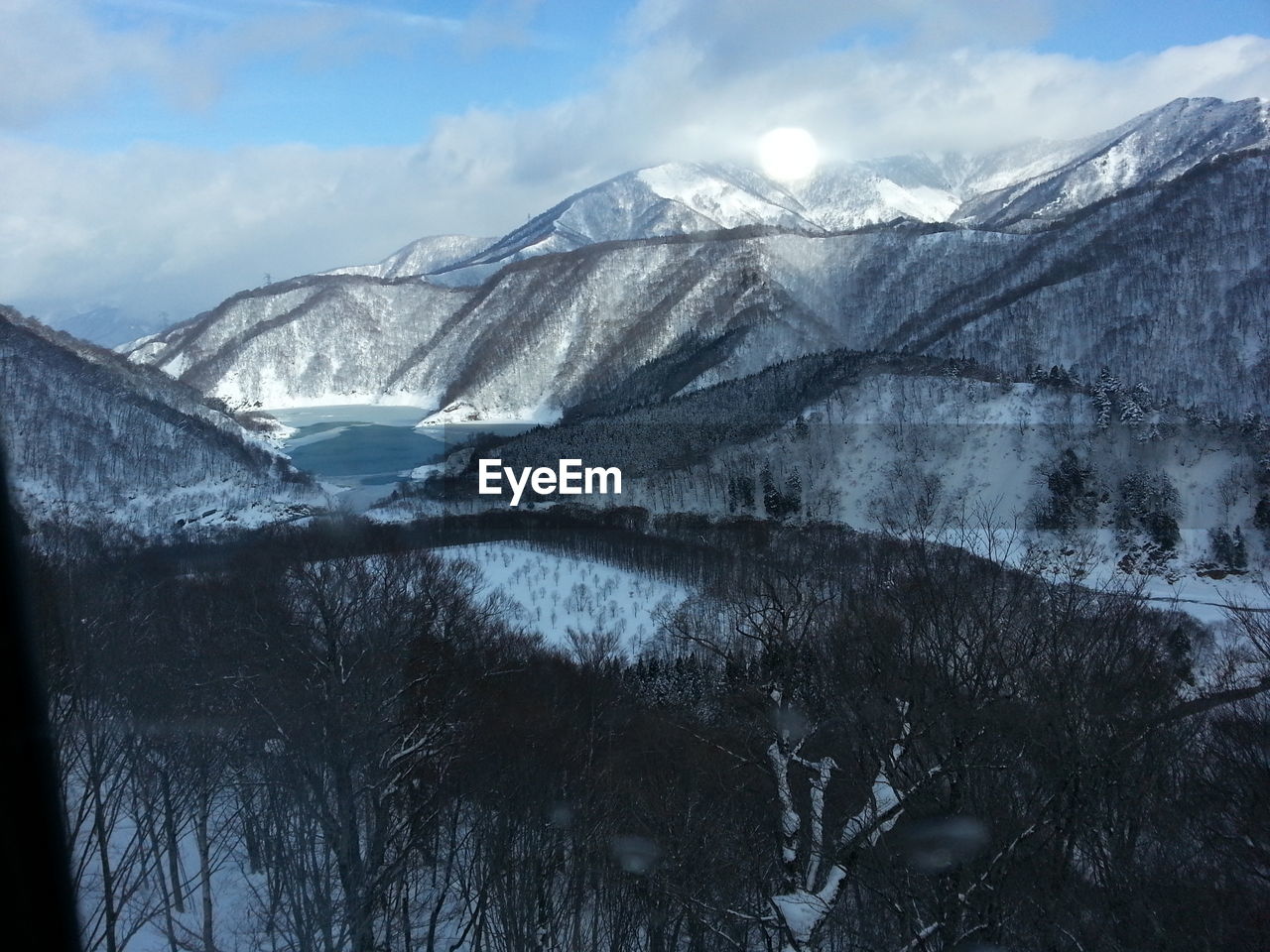 Scenic view of lake and snowcapped mountains during winter