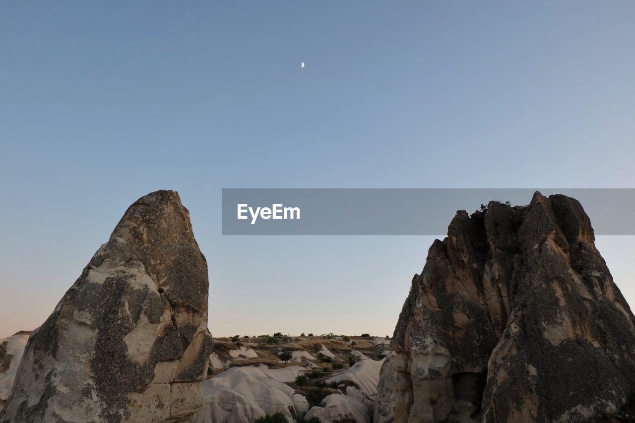 LOW ANGLE VIEW OF ROCKS AGAINST CLEAR SKY