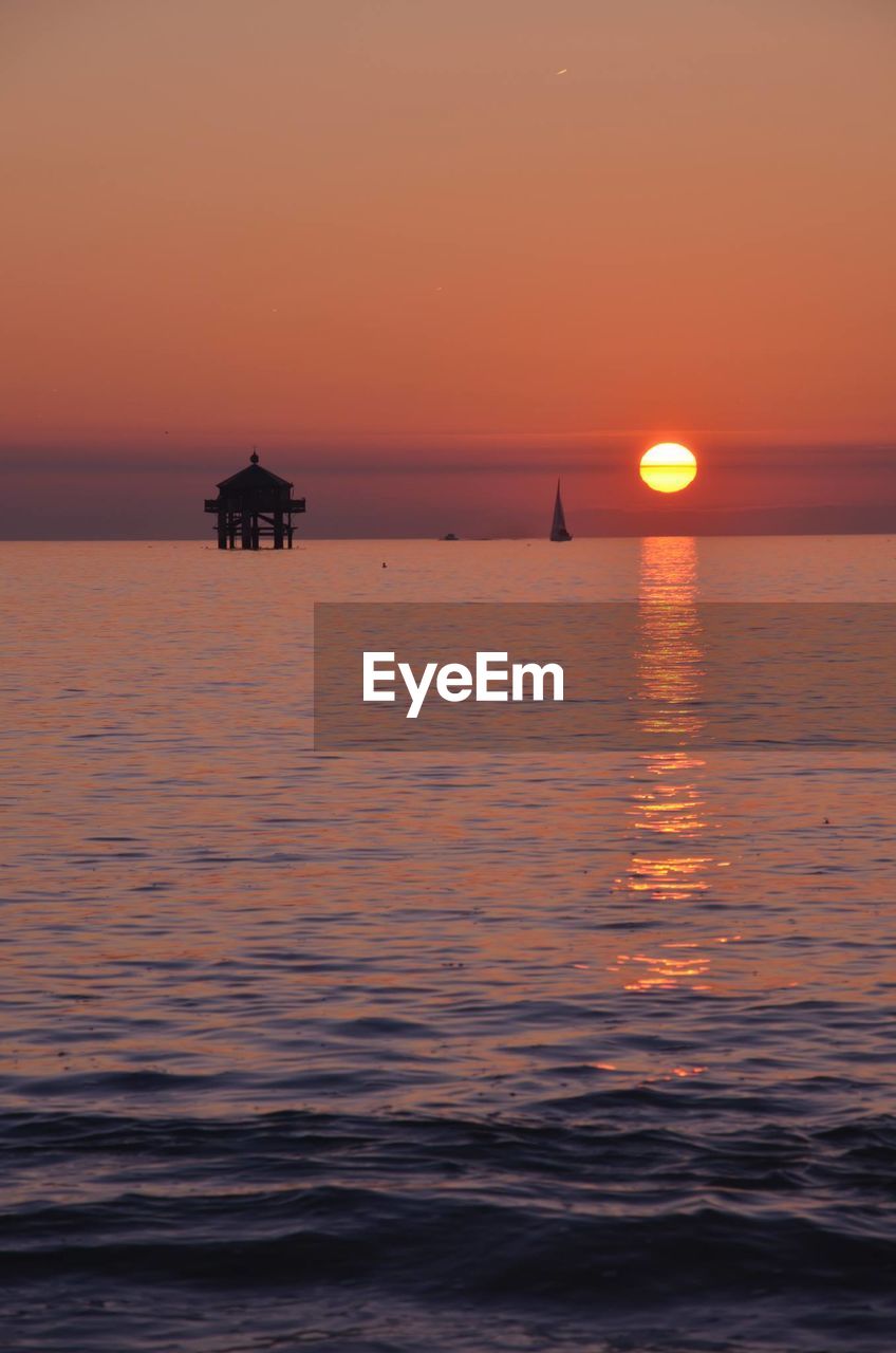 Scenic view of seascape against sky during sunset