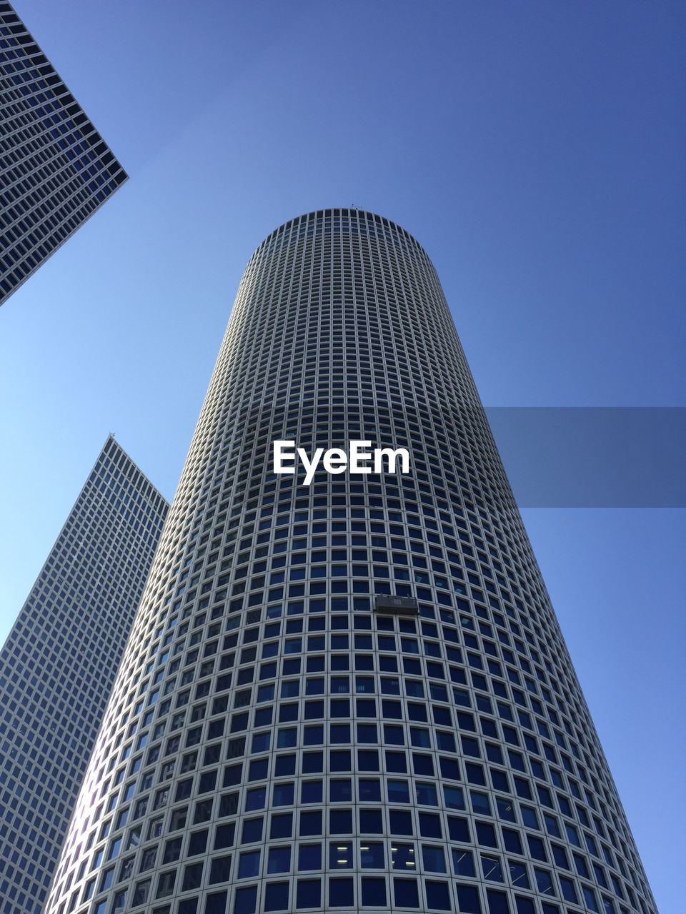 architecture, skyscraper, built structure, building exterior, sky, city, building, blue, office building exterior, clear sky, line, no people, tower block, facade, low angle view, pattern, nature, business, office, day, outdoors, futuristic, technology, landmark