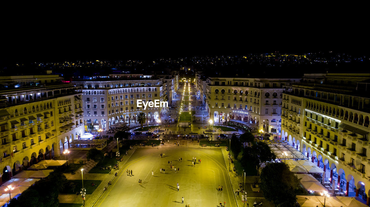 High angle view of city lit up at night