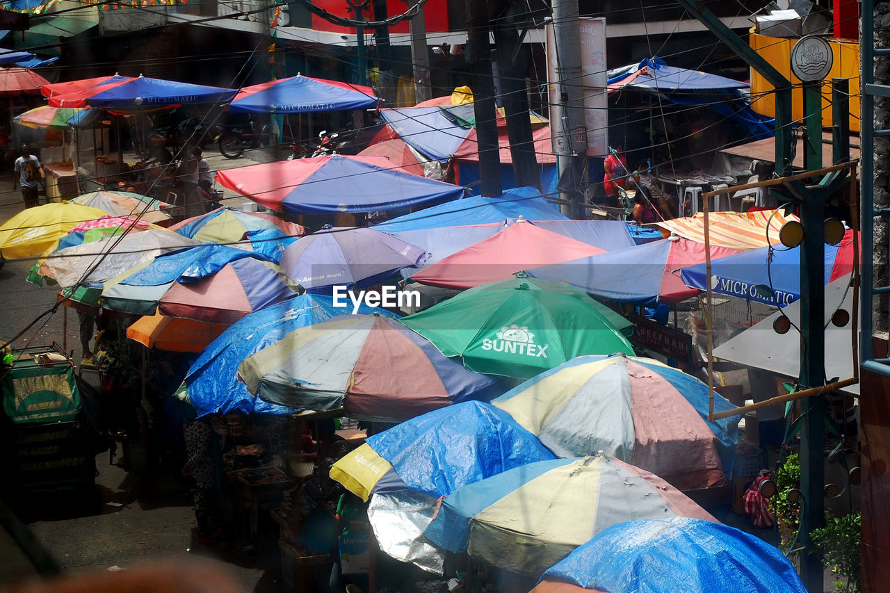 High angle view of parasols at street market