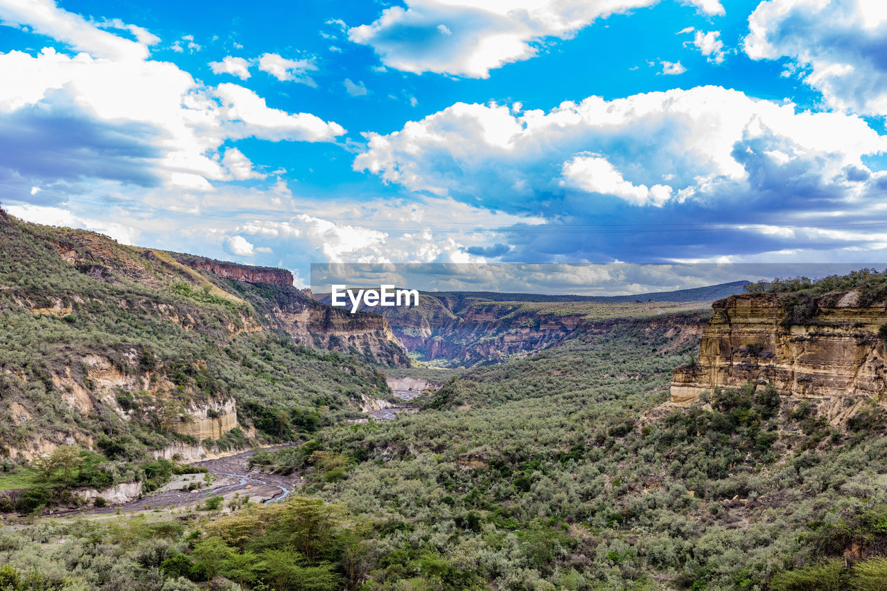 environment, landscape, scenics - nature, sky, mountain, cloud, beauty in nature, nature, land, travel destinations, travel, rock, plant, non-urban scene, no people, tranquility, mountain range, tranquil scene, tourism, tree, valley, plateau, outdoors, rock formation, wilderness, blue, canyon, day, idyllic, remote, semi-arid, forest, extreme terrain, geology