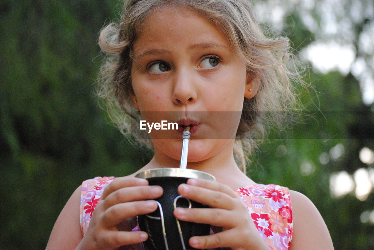 Portrait of girl drinking water