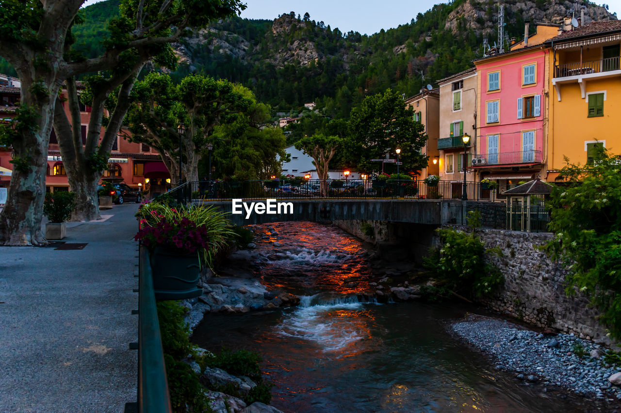 Bridge over river by buildings in city