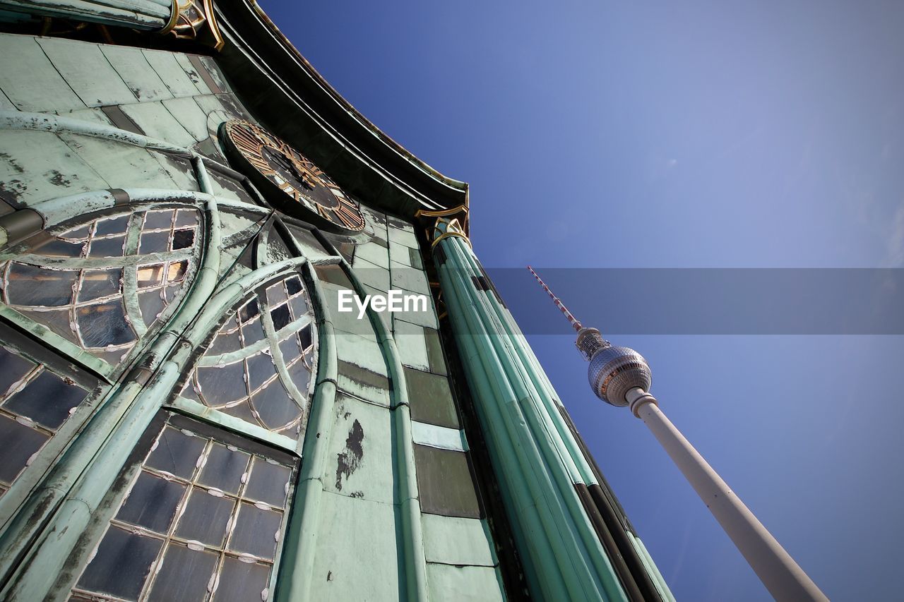 LOW ANGLE VIEW OF BUILDING AGAINST BLUE SKY