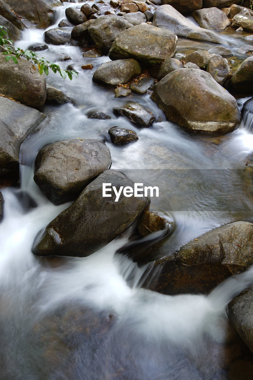 ROCKS IN RIVER STREAM