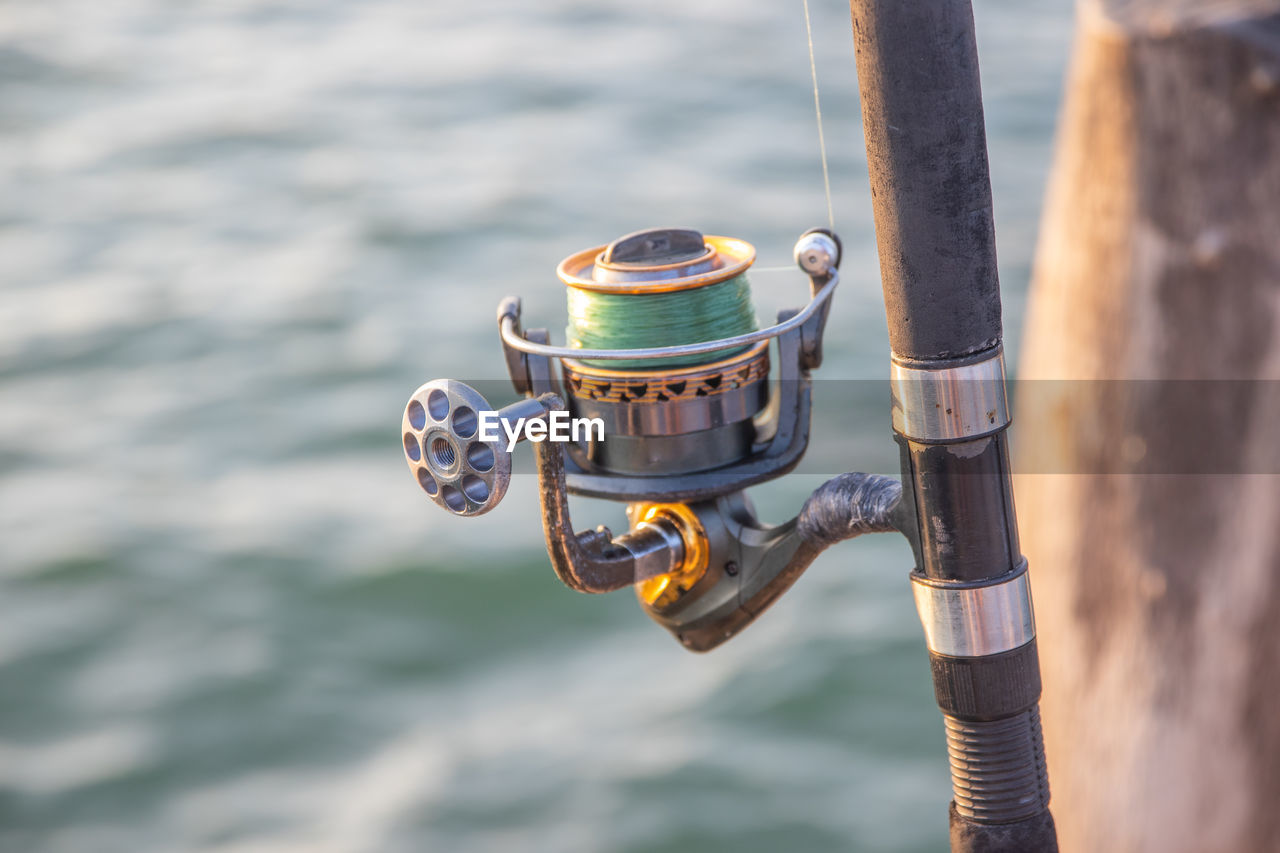 The crank of a fishing rod with reel foot, reel seat, spool, coiled line and spool brake