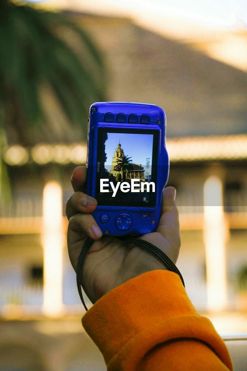 Close-up of hand holding mobile phone