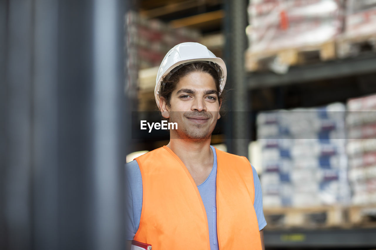 Young store worker with helmet working in a store