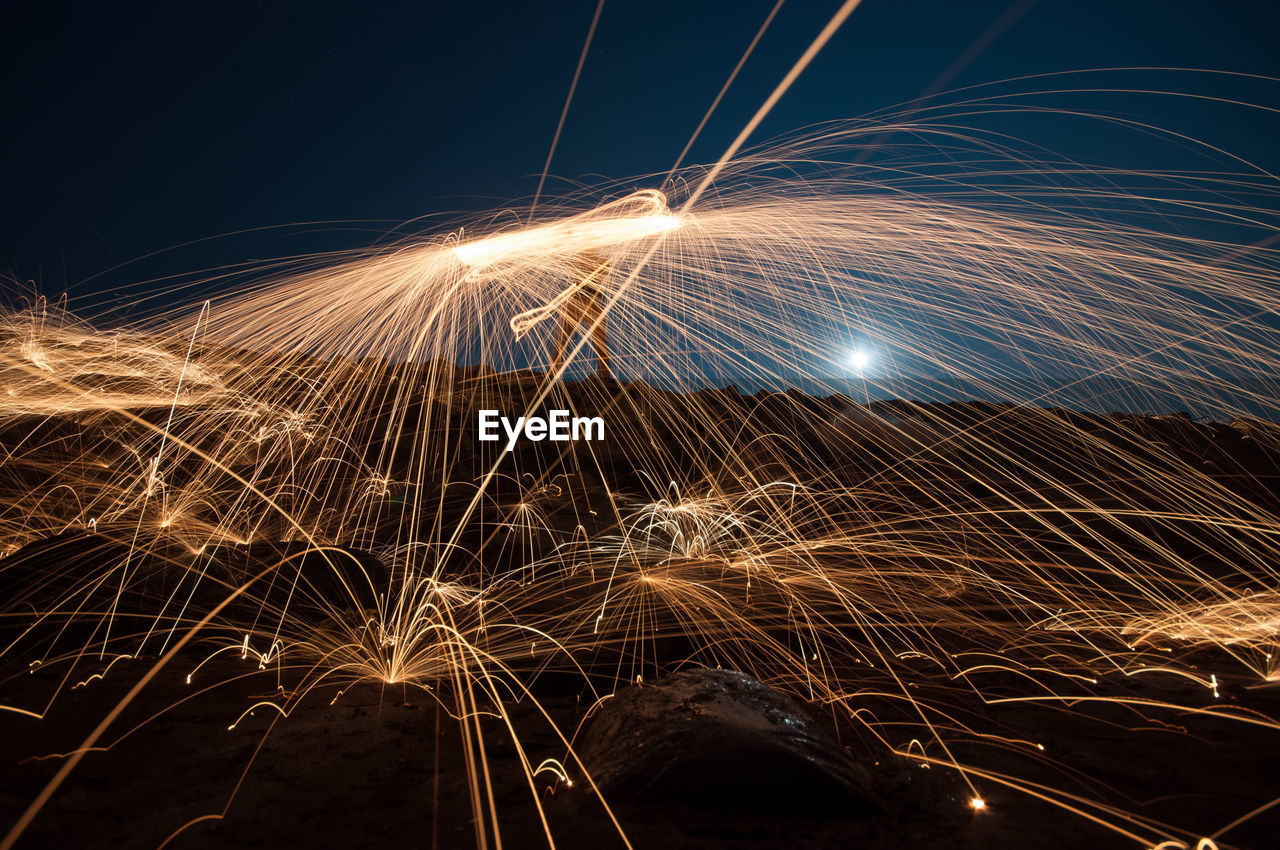 Close-up of wire wool against sky at night