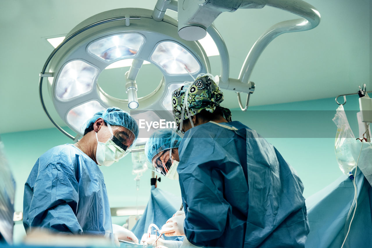 Surgeons performing surgery in operating room