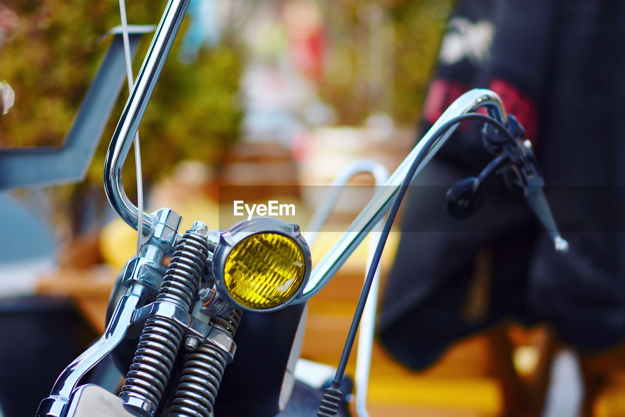 Close-up of bicycle parked on cable
