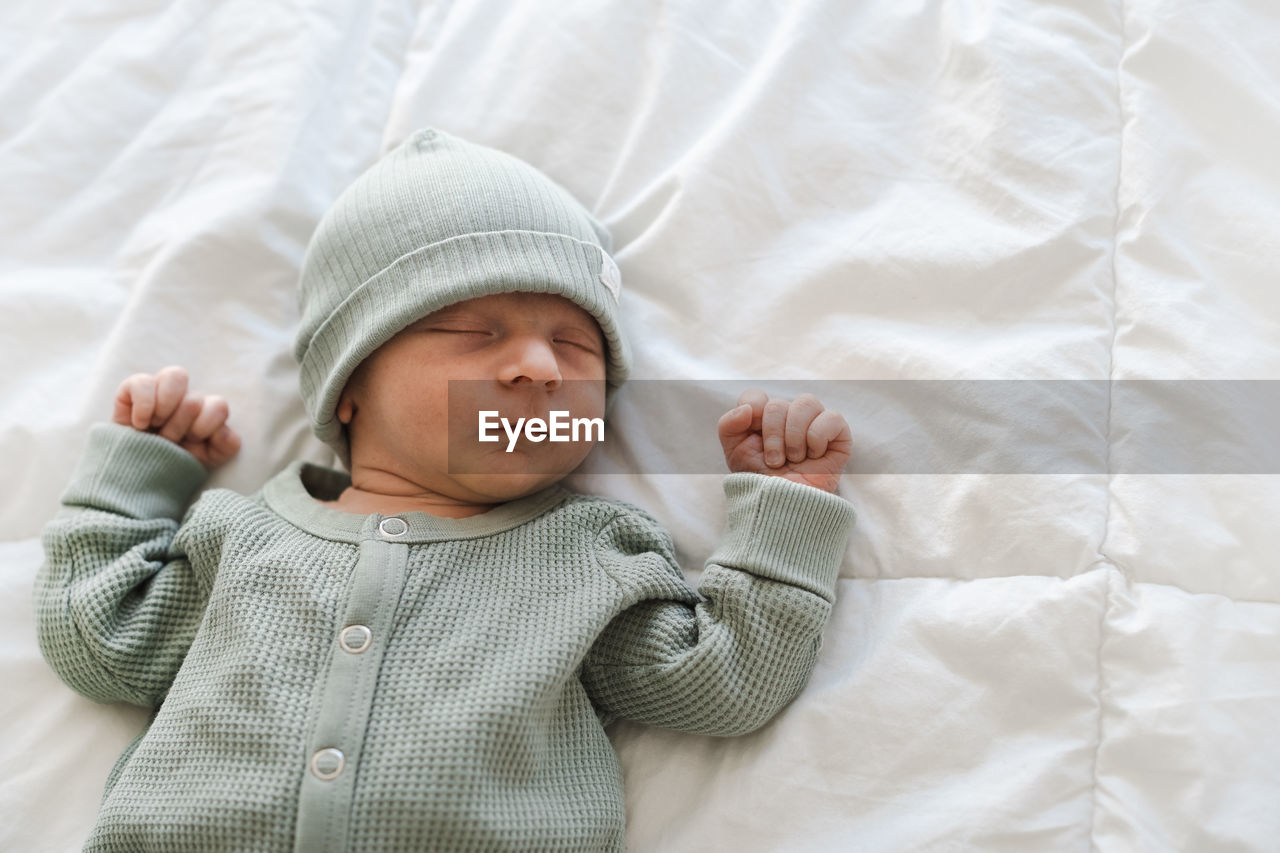 Portrait of cute baby boy sleeping on bed