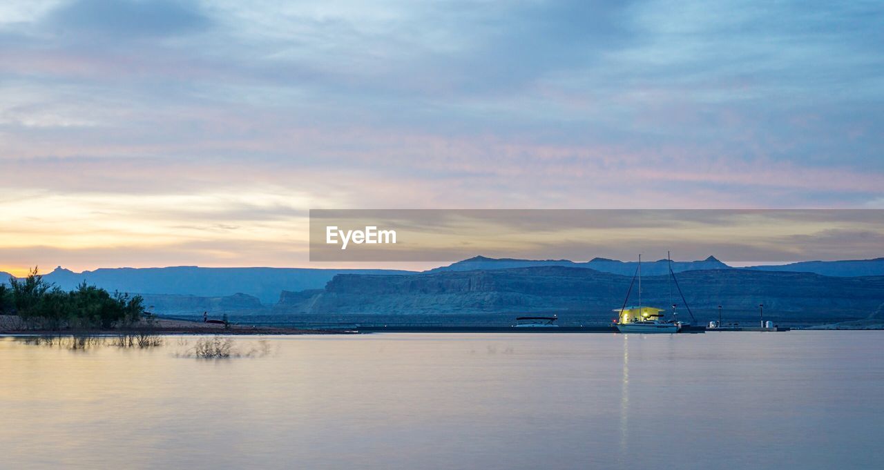 Scenic view of lake against sky during sunset