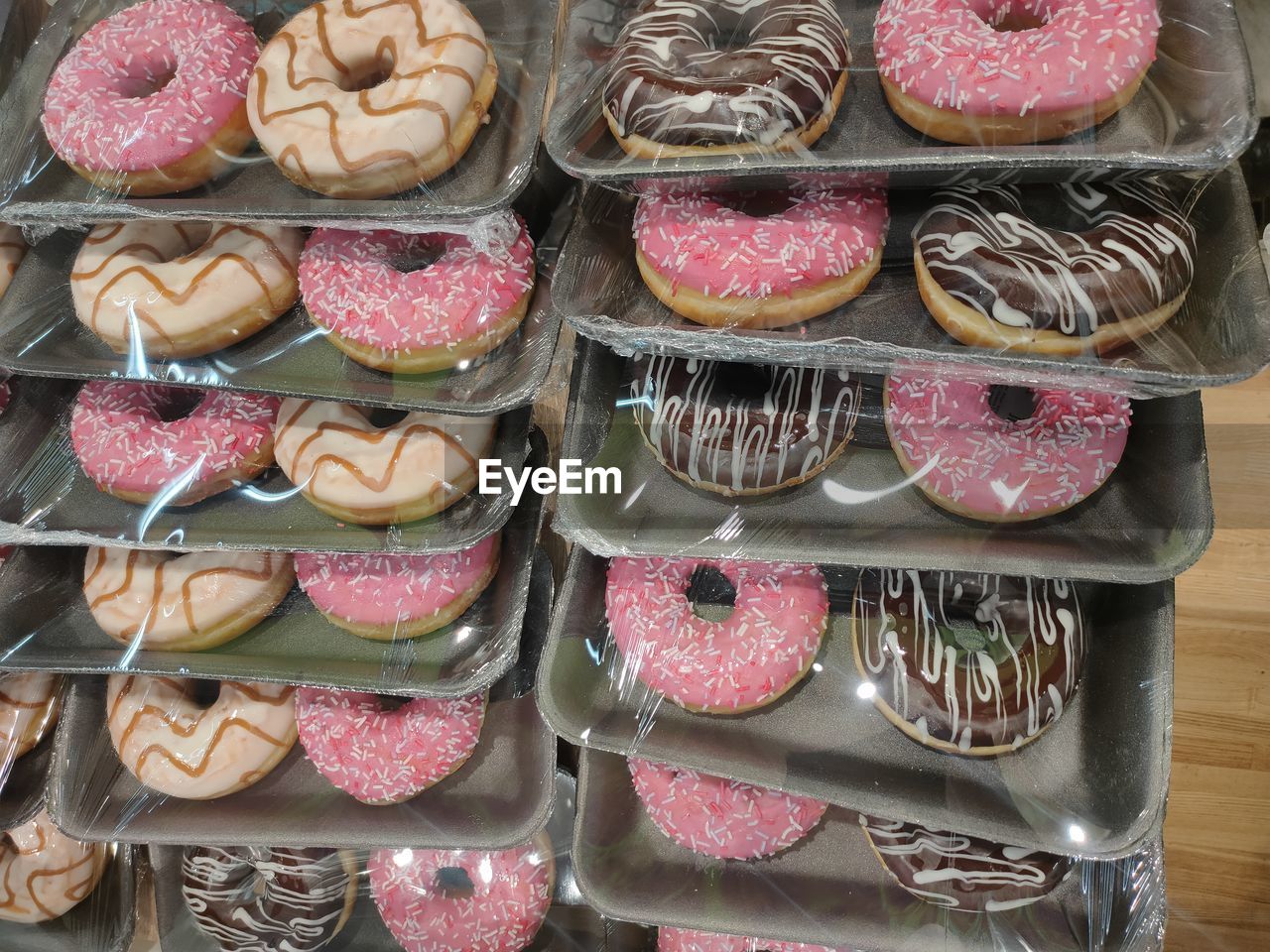dessert, food, food and drink, variation, sweet food, large group of objects, baked, no people, sweet, confiture, abundance, in a row, arrangement, freshness, retail, sweetness, for sale, indoors, still life, container, order, store, multi colored, temptation, unhealthy eating, high angle view, pastry