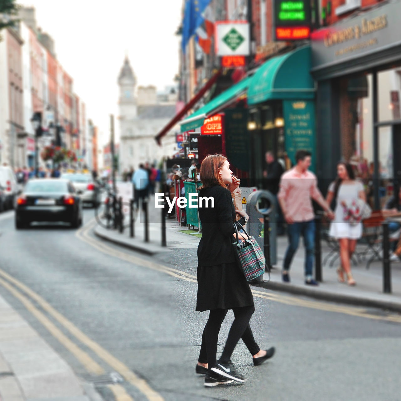 WOMAN WALKING ON CITY STREET