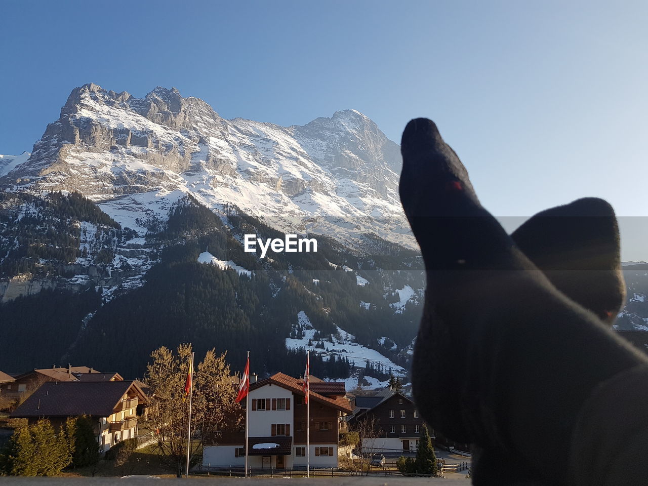 LOW ANGLE VIEW OF PEOPLE ON SNOWCAPPED MOUNTAIN AGAINST SKY