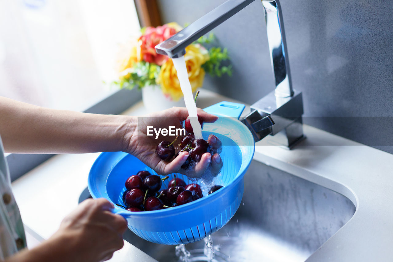 cropped hand of person preparing food at home