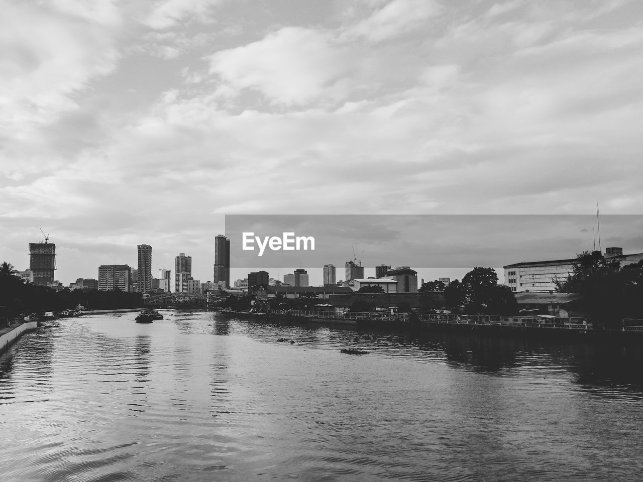 RIVER AND BUILDINGS AGAINST SKY