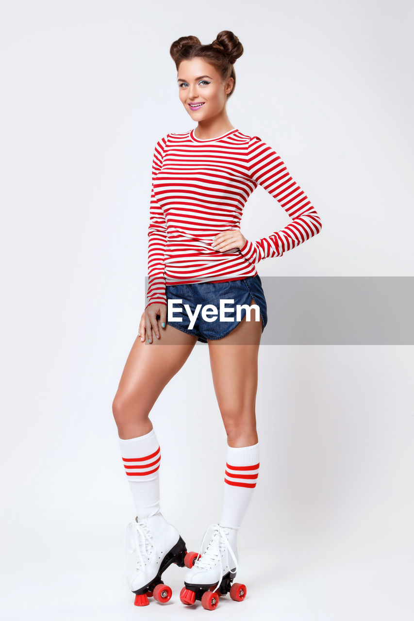 full length of woman standing against white background