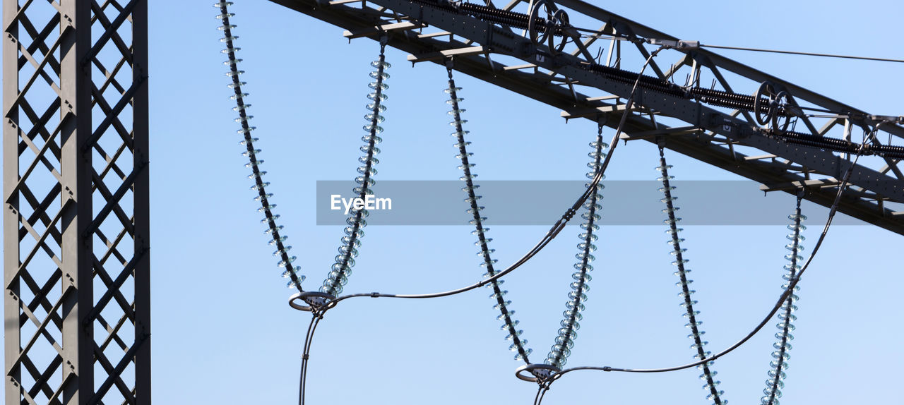 sky, line, electricity, metal, architecture, no people, low angle view, built structure, day, overhead power line, clear sky, net, outdoor structure, nature, mast, outdoors, transmission tower, blue, iron, fence, hanging, tower