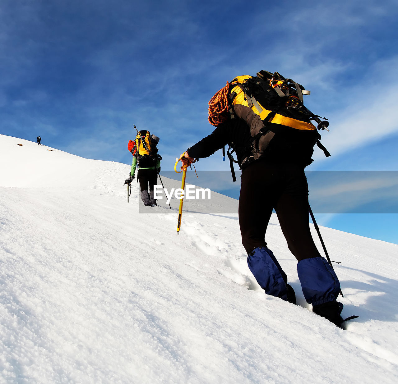 Low angle view of people walking on snowy hill