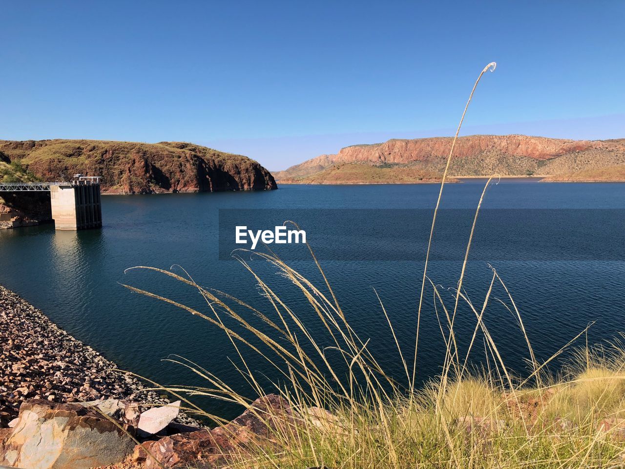 Scenic view of sea against clear blue sky