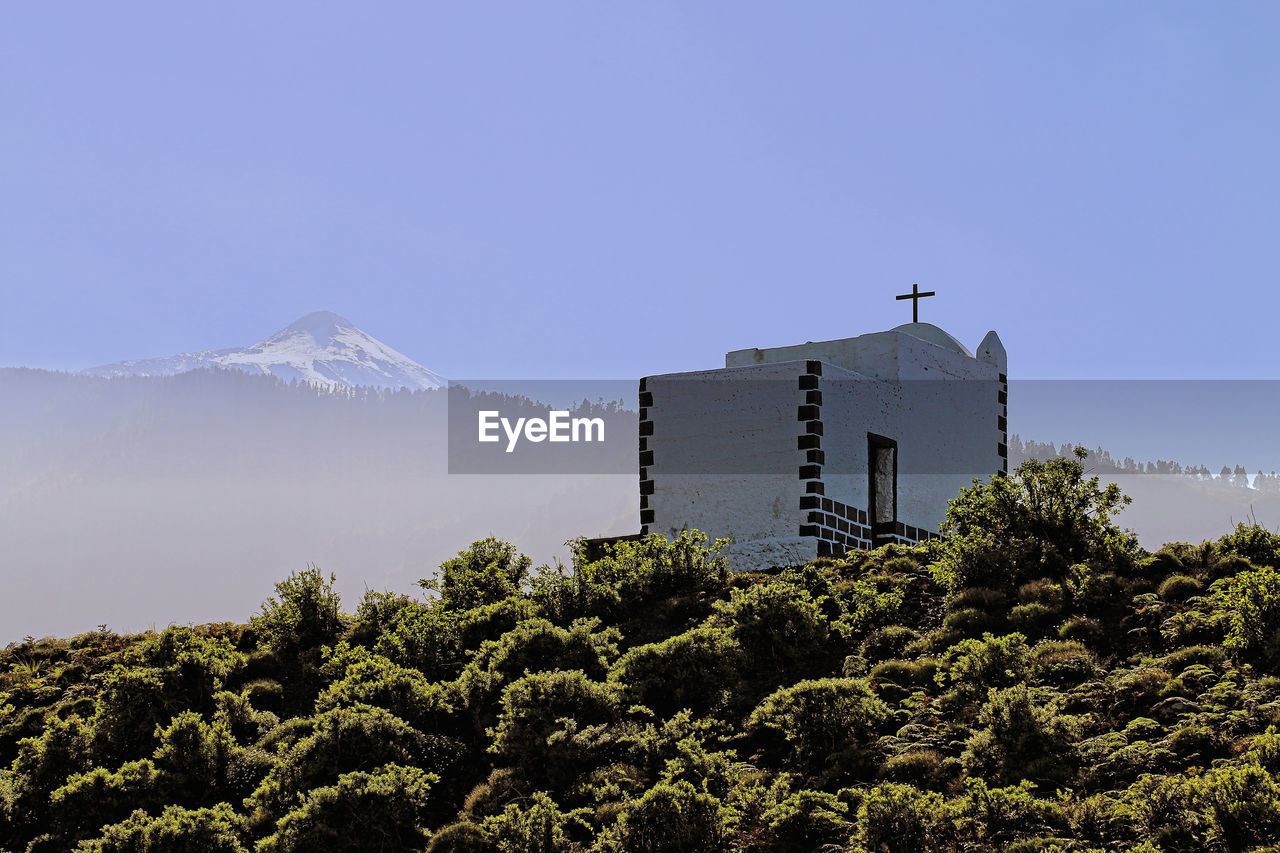 Christian chapel against clear blue sky