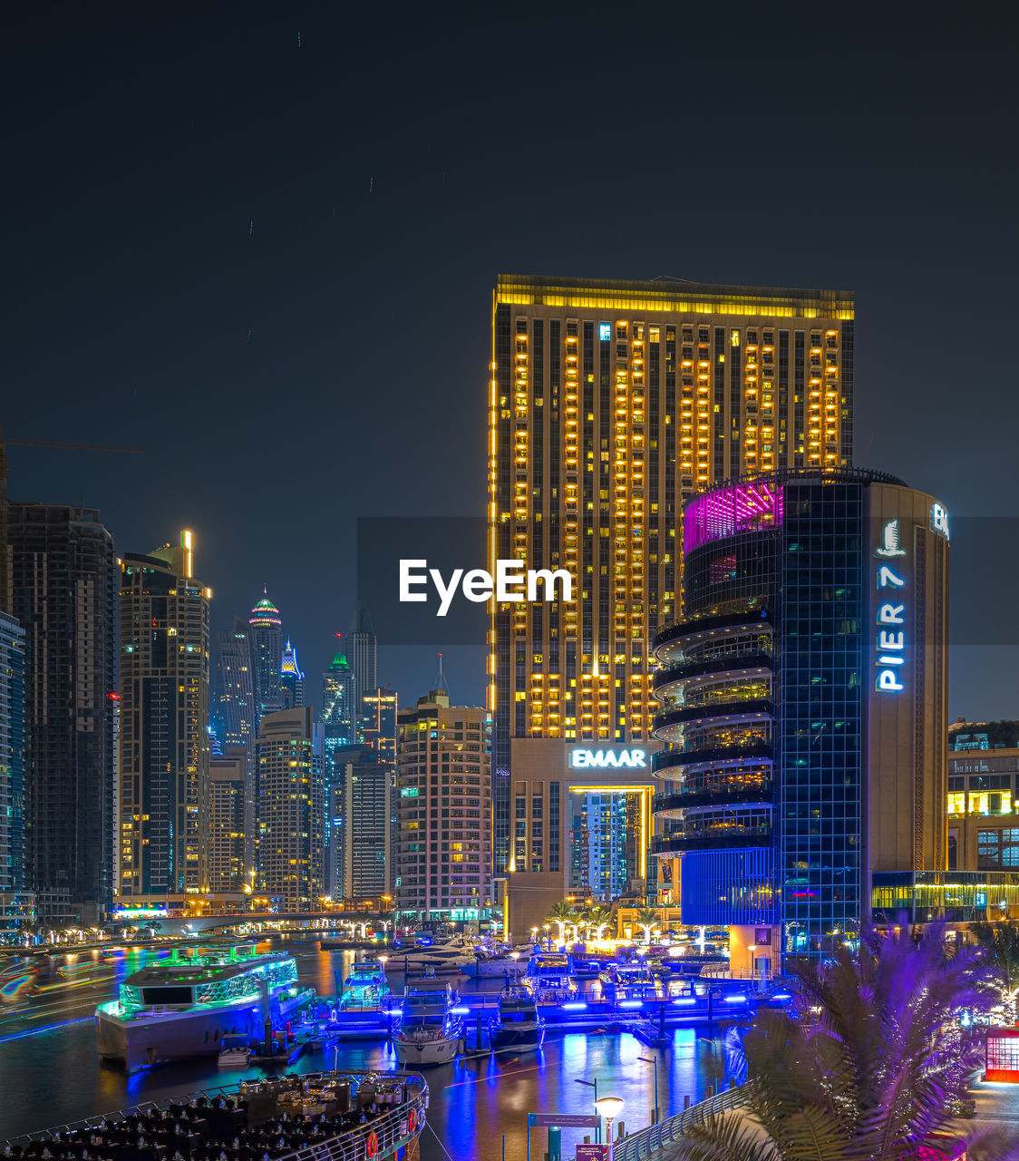 ILLUMINATED BUILDINGS IN CITY AT NIGHT