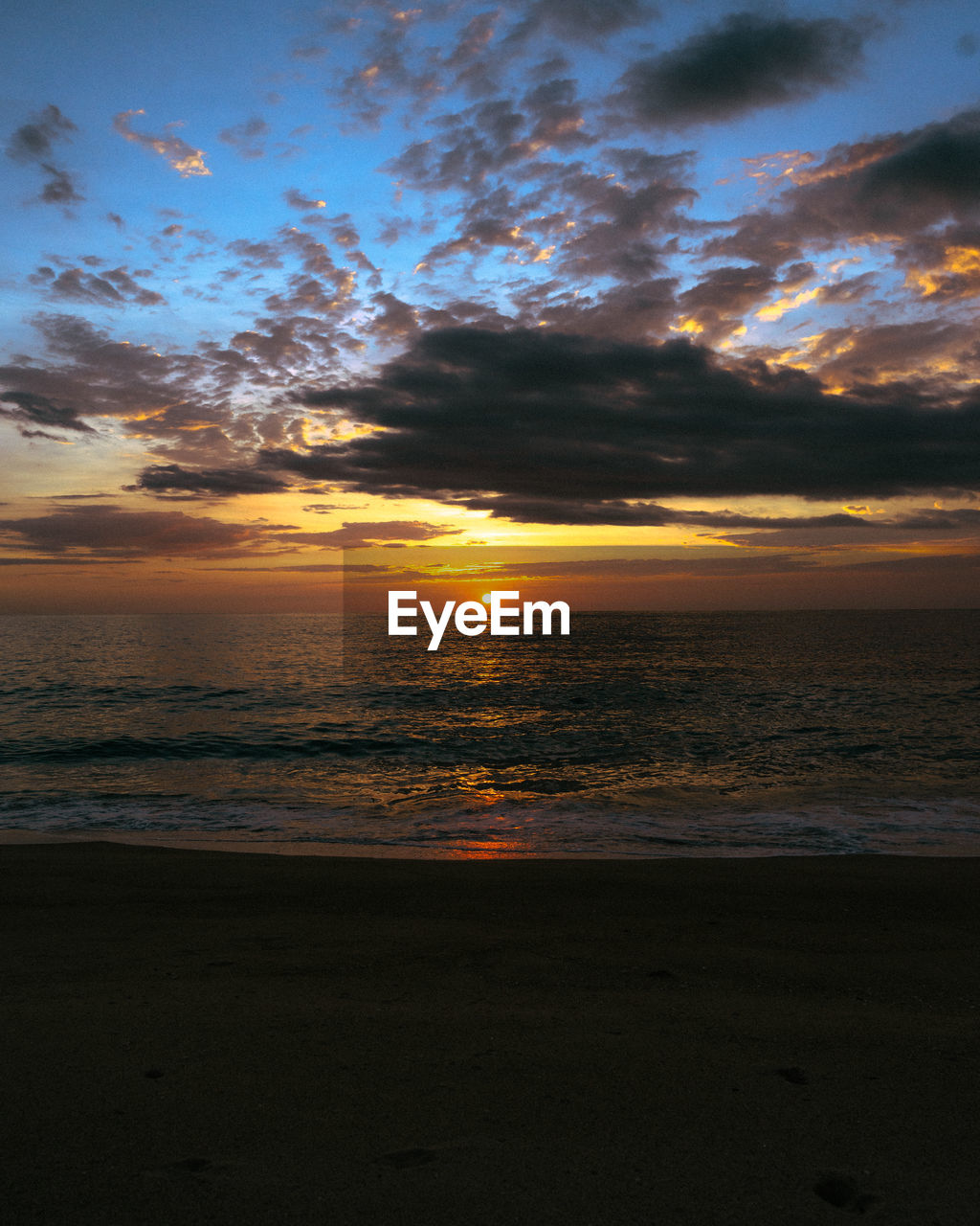 Scenic view of beach against sky during sunset