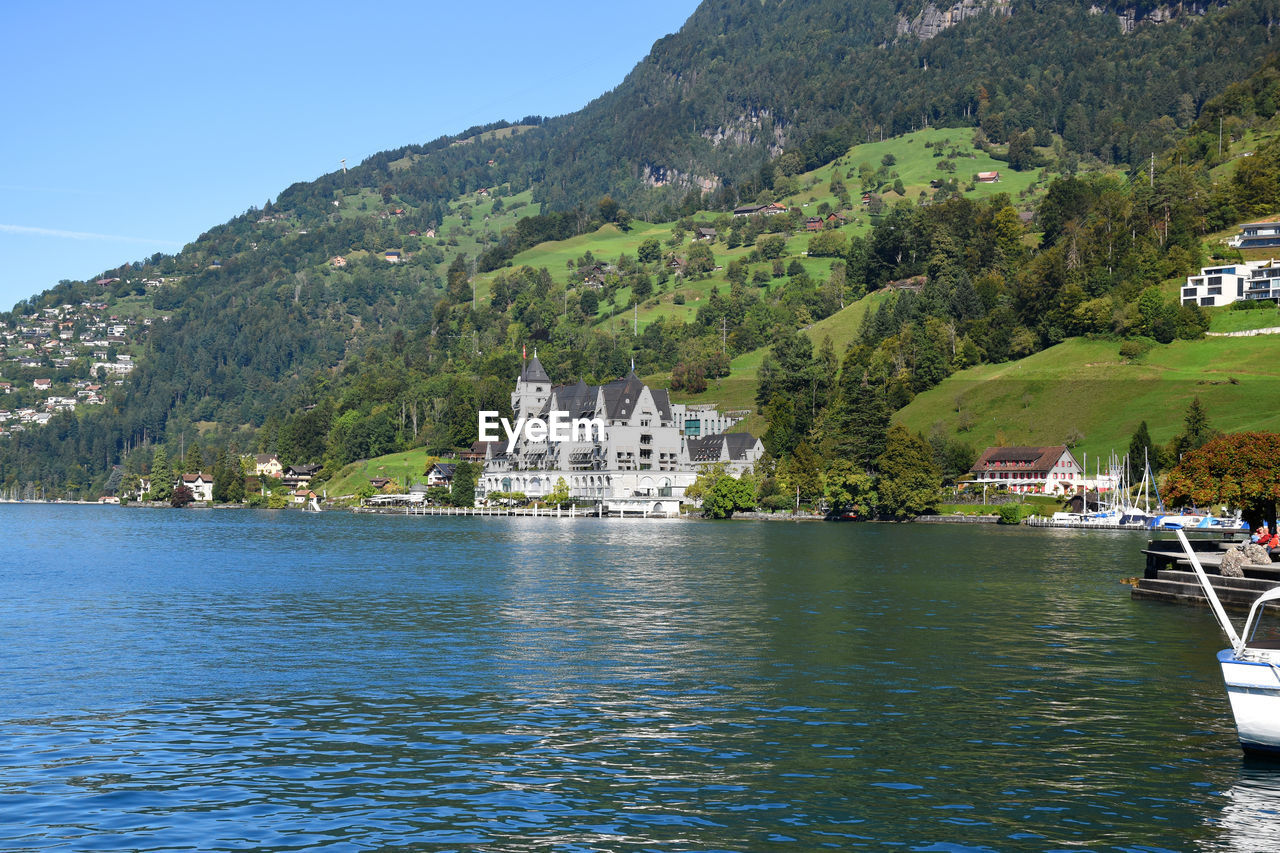 Beautiful green hillside meadow with the view of park hotel vitznau in the front ground