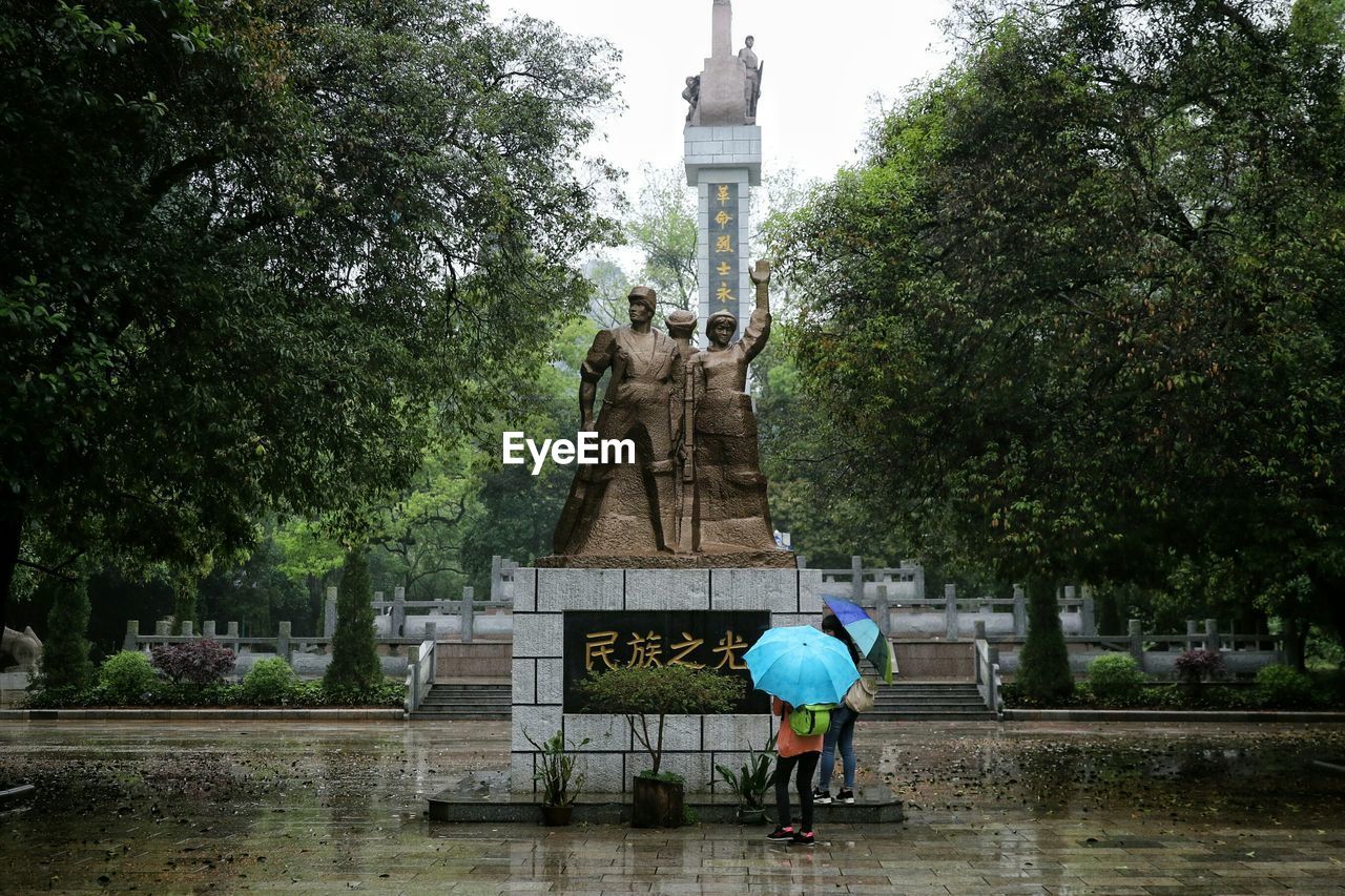 Statue in park during rainy season