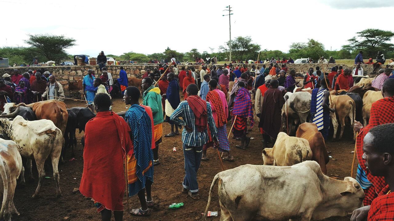 REAR VIEW OF PEOPLE AT STREET