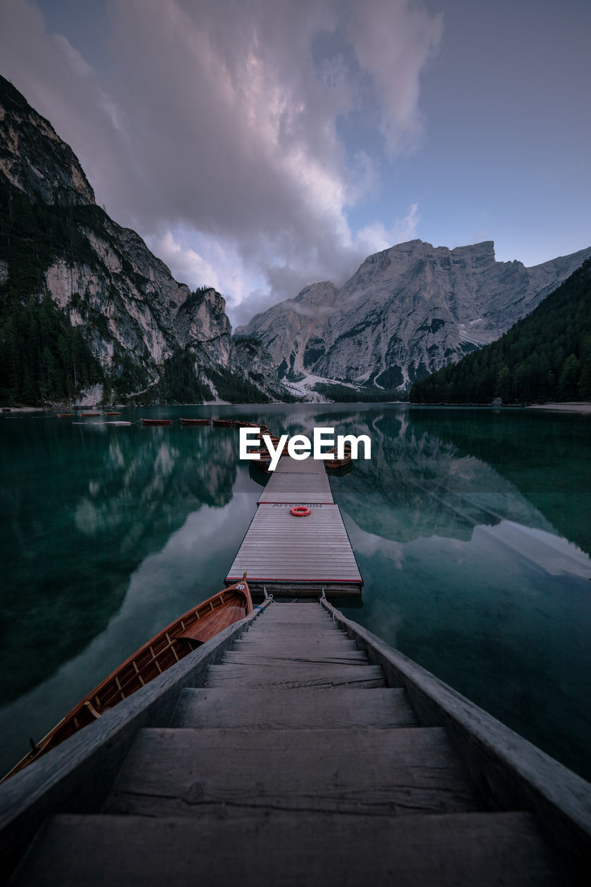 High angle view of boats moored at harbor in lake against mountains