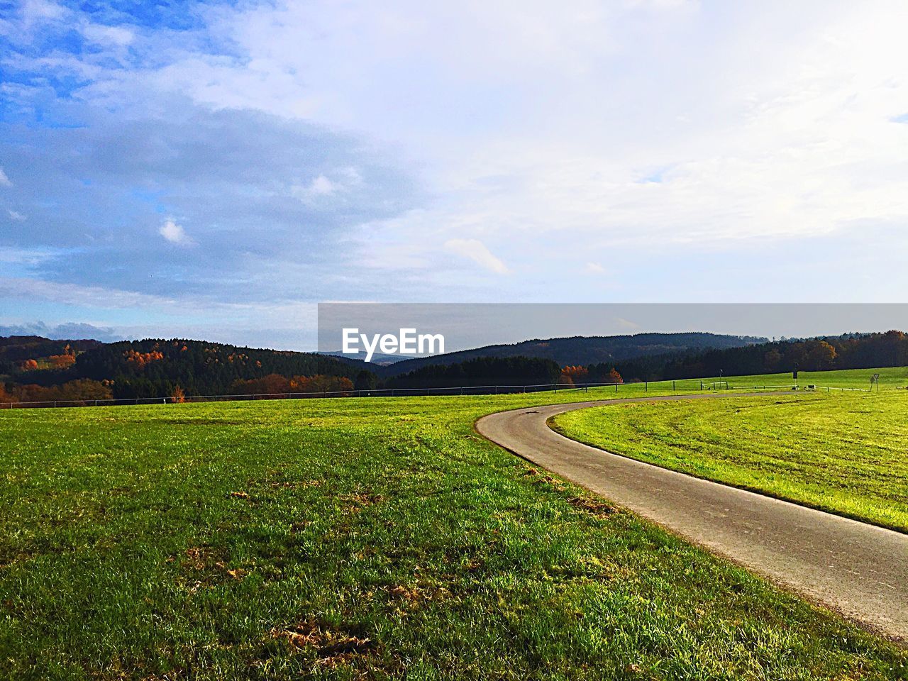 SCENIC VIEW OF GRASSY FIELD AGAINST SKY