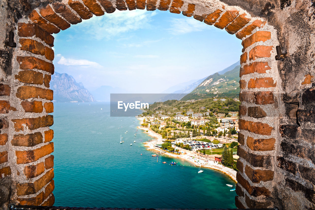 SCENIC VIEW OF SEA SEEN THROUGH WINDOW