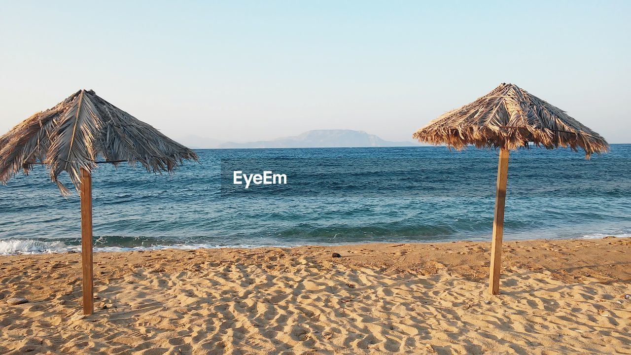 VIEW OF BEACH AGAINST BLUE SKY