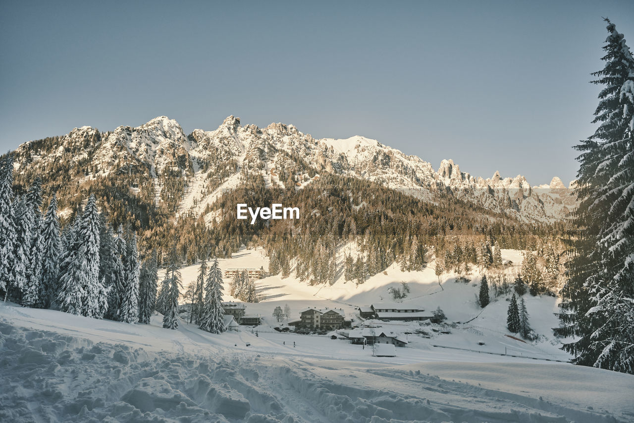 Snow-covered landscape against clear sky