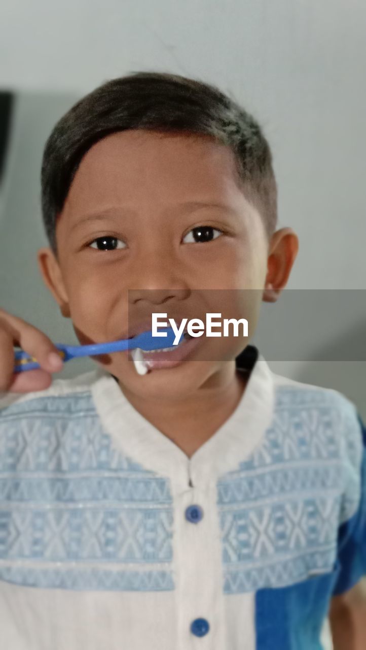 A boy learns to brush his teeth