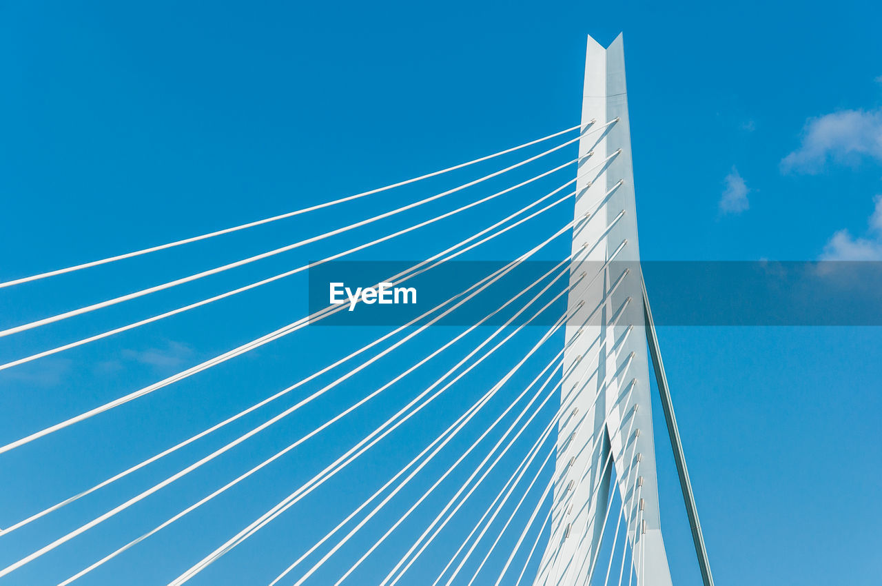 LOW ANGLE VIEW OF BRIDGE AGAINST BLUE SKY