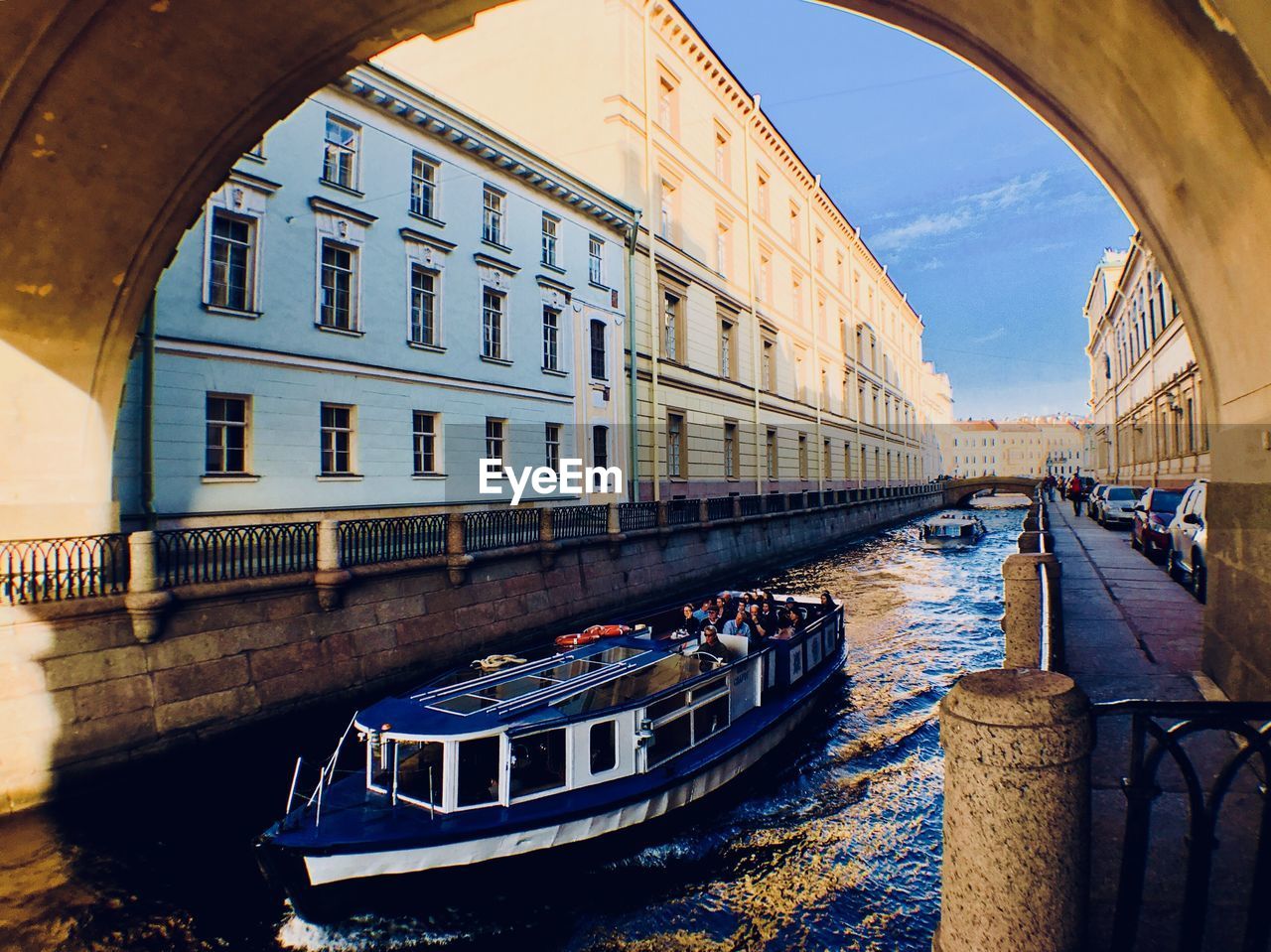 Canal amidst buildings in city against sky