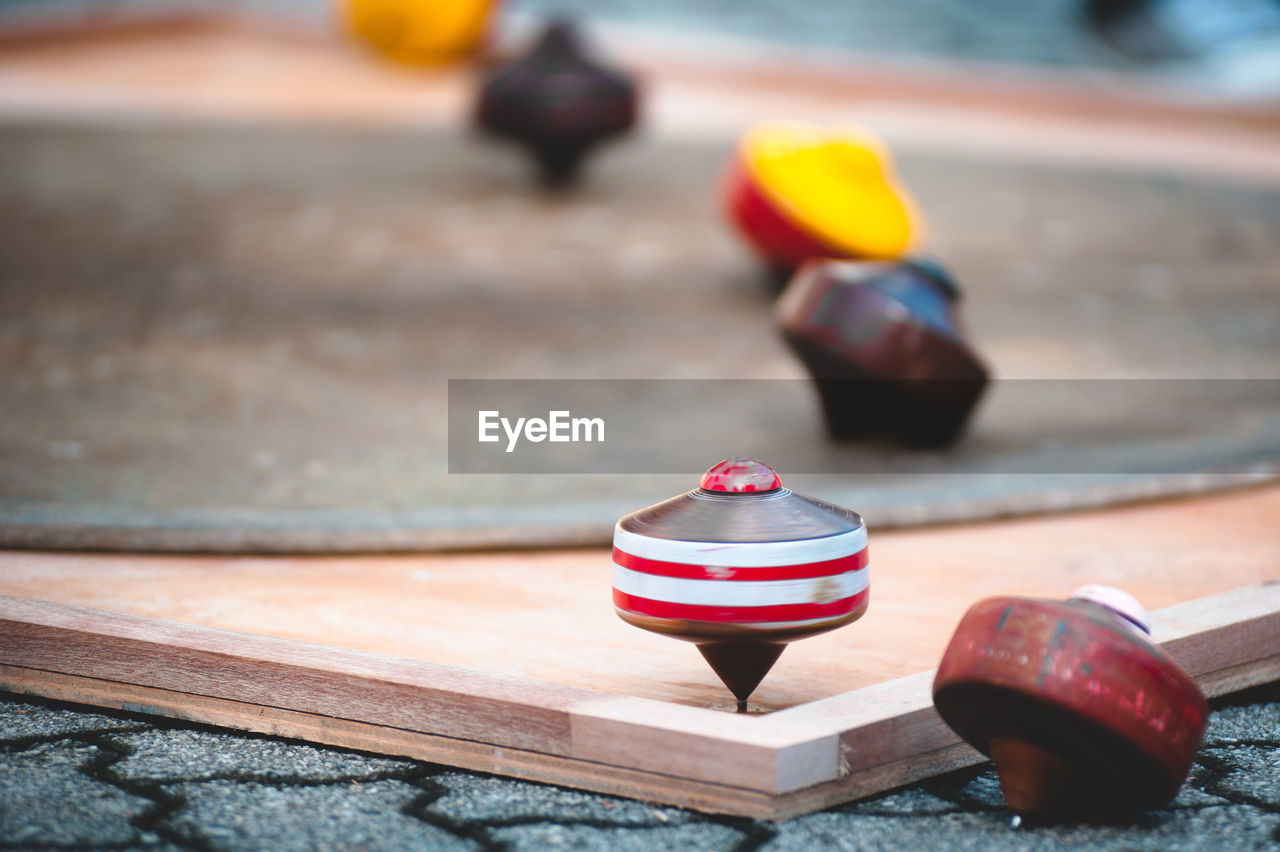 Close-up of spinning tops on table