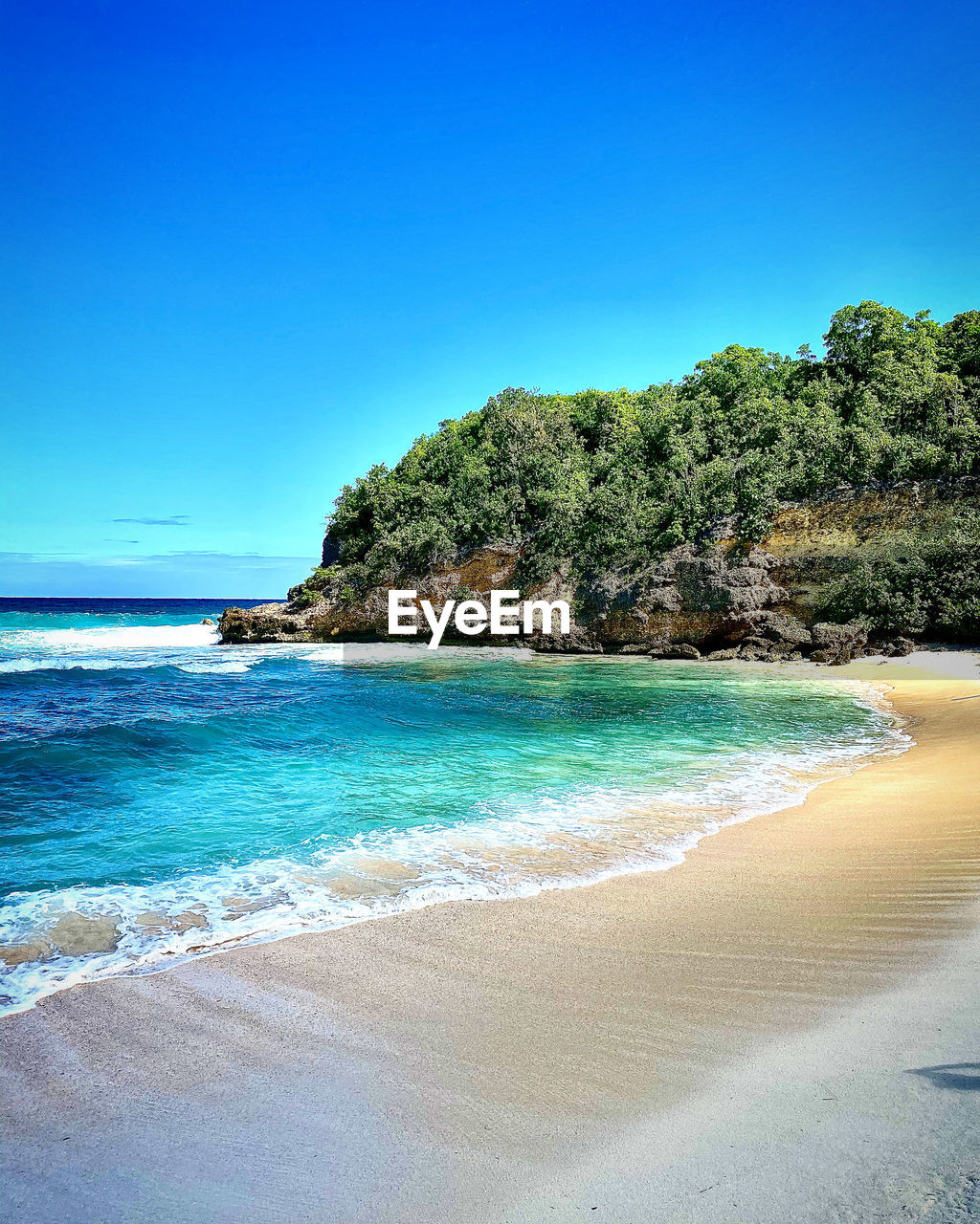 Scenic view of sea against clear blue sky