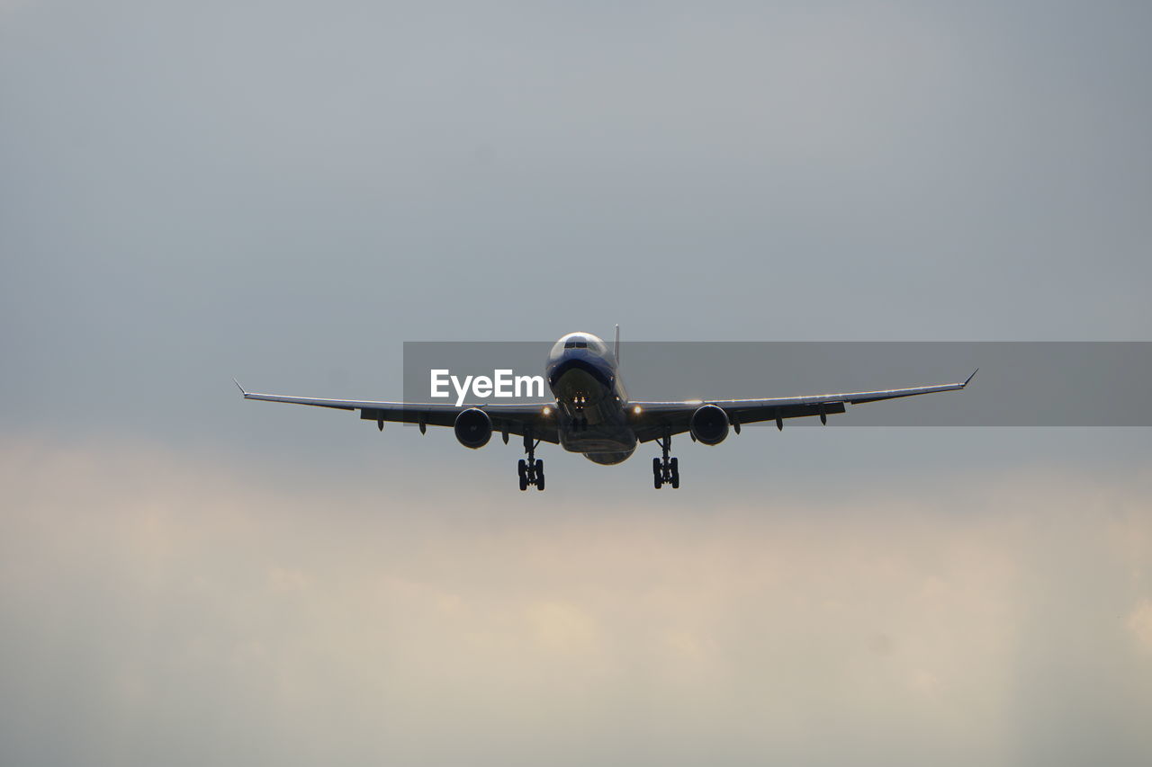 Low angle view of airplane flying in sky